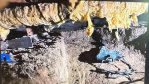 crawlspace-remediation Specialized tight-access excavation inside a low-clearance crawlspace using a jackhammer for foundation remediation.