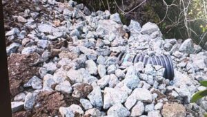 rip-rap-drainage Large rip-rap rock armor installed around a drainage pipe outlet to provide permanent erosion control on a slope.