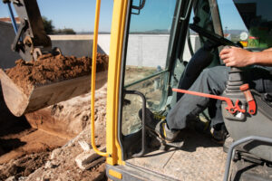 demolition and removal Construction worker operating an excavator during demolition and removal